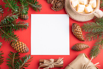 Christmas or New Year frame composition. Decorations, cones, fir and spruce branches, cup of coffee, on a red background. Top view, copy space.