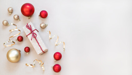 Christmas composition with gift box and Christmas ornaments on light background. Christmas greeting card. Christmas flat lay. stock photo