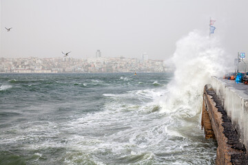 Fototapeta na wymiar Maidens Tower and southwest wind storm with waves in Istanbul,Turkey