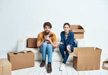 Fototapeta na wymiar Married couple moving boxes with things lifestyle emotions interior
