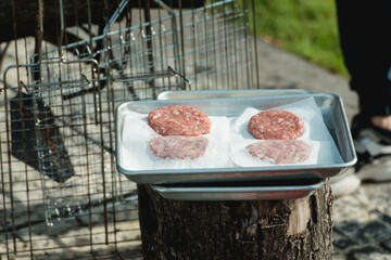 Beef and Pork Patty for Burger. Cooking Cutlets on Mangal. Grill Minced Meat. Chef Cooks burger in street outdoors. Summer Picnic in Nature. Tasty Meat Dish.