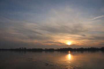 Naklejka na ściany i meble Beautiful sunrise on the Vistula River, Chelmno, Poland, reflection in water.