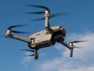 radio-controlled drone is filming nature on sky background