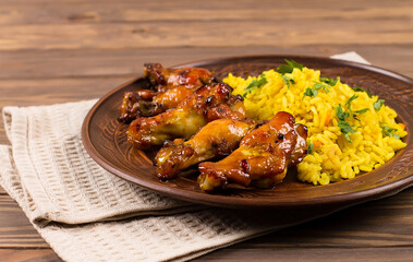 West African food. Rice with fried chicken, herbs and spices, on a plate