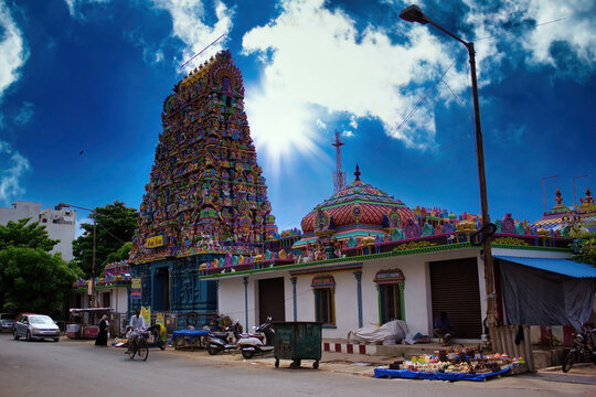 Pondicherry, India - October 30, 2018: Wide angle shot of An Indian colorful temple named Vedapureeswarar exterior displaying beautiful hindu architecture with gods sculpture carved on it's built.