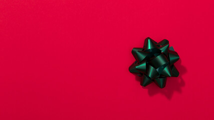 Green bow on the red background - Gift box