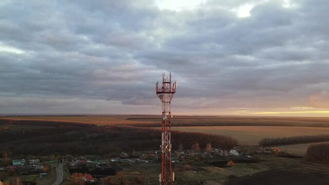 Telecommunication tower of 4G and 5G cellular or Base Transceiver Station in countryside village. Wireless Communication Antenna Transmitter. Aerial view footage