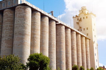 Concrete elevator, grain tank on a sunny sky background