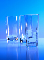Empty glass on blue background