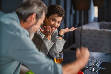 aged couple in the kitchen talking about something