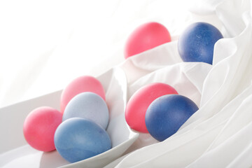 Blue and pink easter eggs on white background