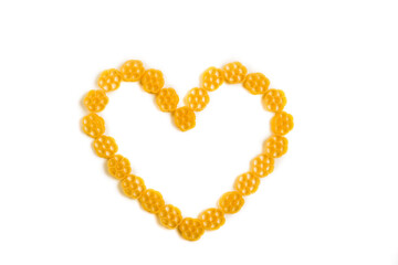 Heart shape made of raw Italian pasta isolated on white background