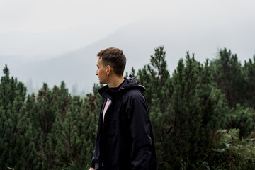 Men tourist is travelling and walking to the peak of mountain. Hiking and climbing up to the top of the mountain. Tourism in Ukraine.