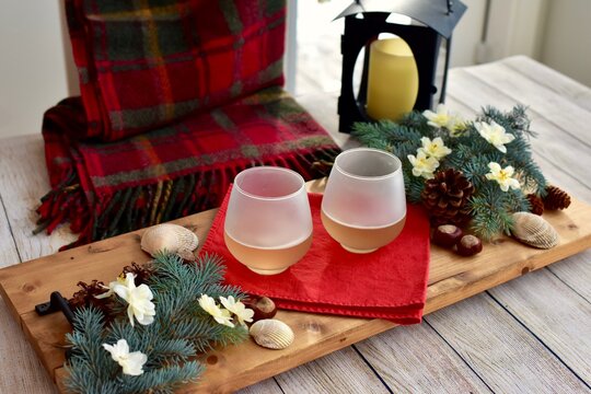 Seasonal Winter holiday tabletop decor for cozy sipping white wine relaxing at home