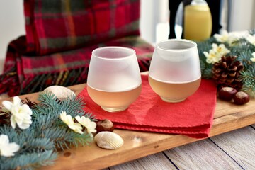 Seasonal Winter holiday tabletop decor for cozy sipping white wine relaxing at home