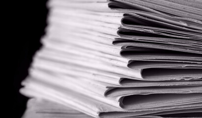 bundles bales of paper documents. stacks packs pile on the desk in the office on black background
