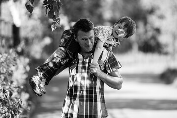 Father and son in the park. Black and white photo.