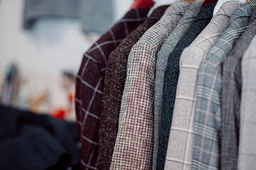 classic jackets on a hanger in a clothing store. natural material, wool, linen cotton.