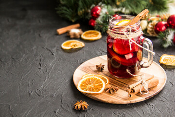 Christmas hot mulled wine with cinnamon cardamom and anise. Dark vintage dirty background. Creative...