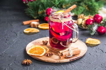 Christmas hot mulled wine with cinnamon cardamom and anise. Dark vintage dirty background. Creative...