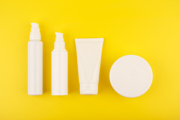 Minimalistic concept of skin care. Flat lay with different skin creams for face and body care on a...