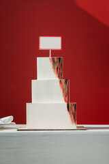 Big white Layered Square Cake on a red background