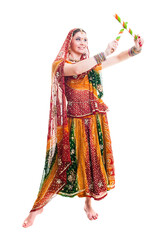 Beautiful young female Bollywood dancer in traditional vivid orange dress with veil and sticks