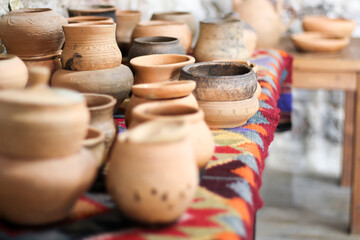 Fototapeta na wymiar handmade clay ware.Pottery Craft Ceramic. clay dishes . Ceramic tableware is handmade on the counter . handmade clay ware.Pottery Craft Ceramic. Different pottery products: bowls, vases, jars 