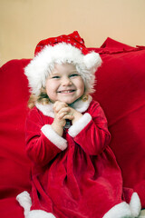 little girl dressed look like miss Santa earnestly beseech that Santa Claus bring her present in Christmas