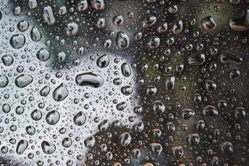 Rain drops on glass background. Raindrops on glass with reflection