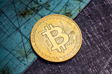 Golden bitcoin coin isolated on scratched metal grunge background.