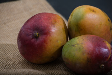 table with mango fruits. dark background with space for text