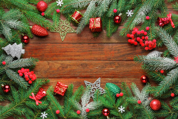 Christmas spruce branches with berries, toys and Christmas decorations frame. Copy space, top view
