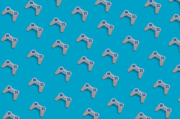 Pattern with retro game joypad controllers on pastel blue background. Flat lay design © Drpixel
