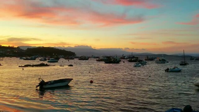 Anchored boats at the dusk on Xufre harbor in Arousa Island, Galicia, Spain