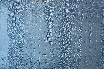 Naklejka na ściany i meble Water drops on window - close up