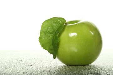 Green apple on wet background