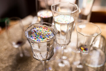 Several champagne glasses over gold christmas background. Celebrating new year concept.