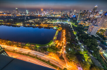 Fototapeta na wymiar Panoramic View of Bangkok, Thailand. Cityscape with Public Park and Skyscrapers at Twilight