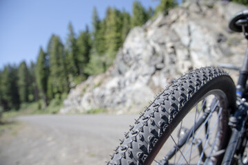 close up of a bike tire climinb a mountain