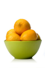 Studio shot of lemons in green bowl