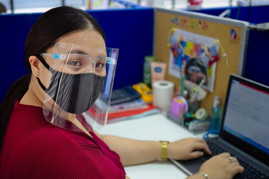 Closeup Of A Southeast Asian Female In A Mask And Face Safety Shield