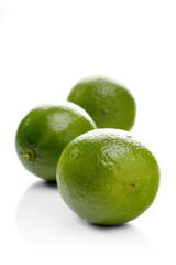Limes on white background - close-up