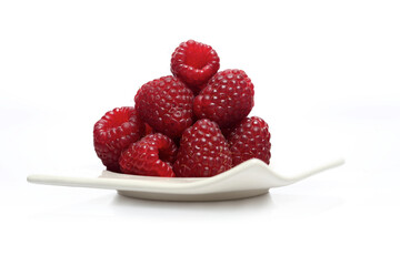 Raspberries on white plate - studio shot