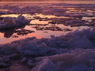 Fototapeta na wymiar Ice drift on the Vyatka river during the winter dawn