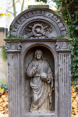 Historic Statue on the autumn mystery old Prague Cemetery, Czech Republic