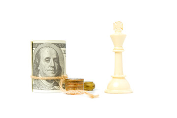 Selective focus of white chess king with fake cash and coin insight. Kingmaker and cash is king...