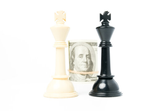 Selective focus of black and white chess king with fake cash insight. Kingmaker and cash is king concept.