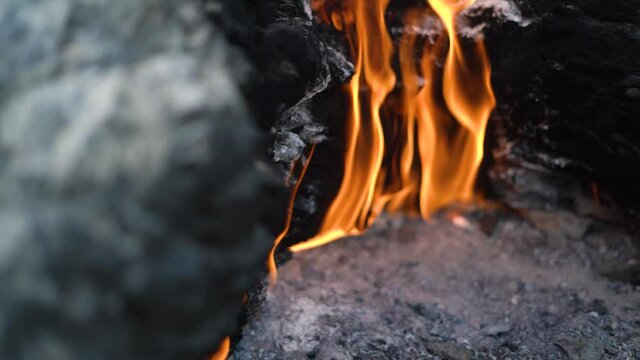 Bright flame of unique natural phenomenon with release of methane and ignition from electricity on famous Turkey mountain Chimaera slope extreme close view.
