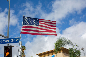 American flag flying in front of blue sky